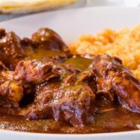 Chicken Mole Plate · Chicken smothered with authentic sweet chocolate sauce, served with rice and tortillas.