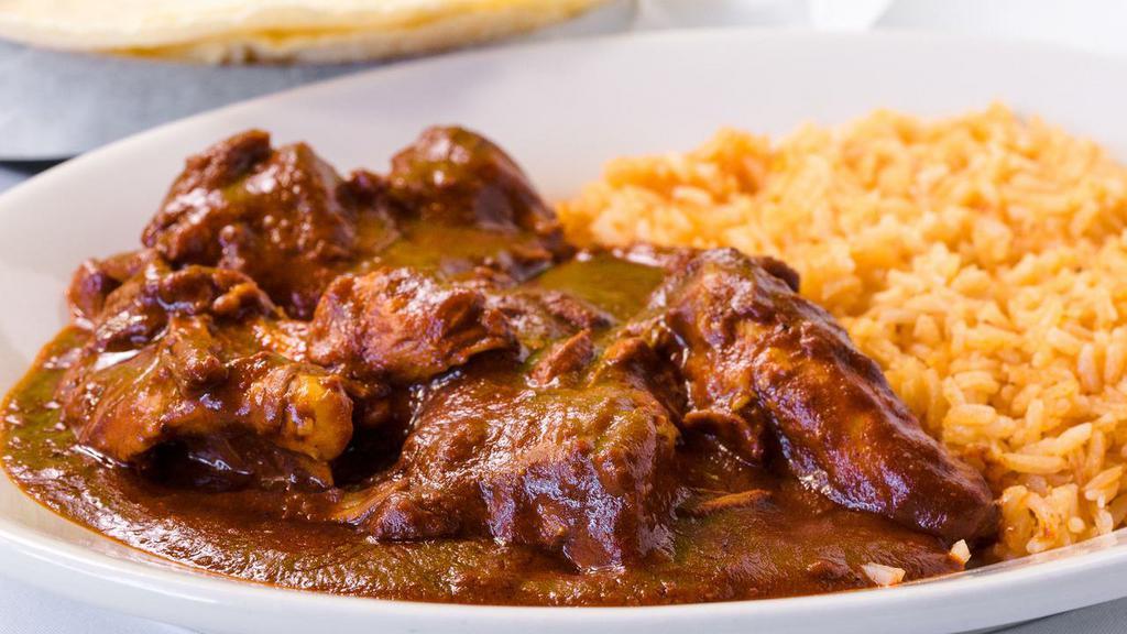 Chicken Mole Plate · Chicken smothered with authentic sweet chocolate sauce, served with rice and tortillas.