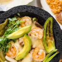 Molcajete Mix or Shrimp · Grilled chicken with chorizo, or steak, nopales, spicy sauce and melted cheese, garnished wi...