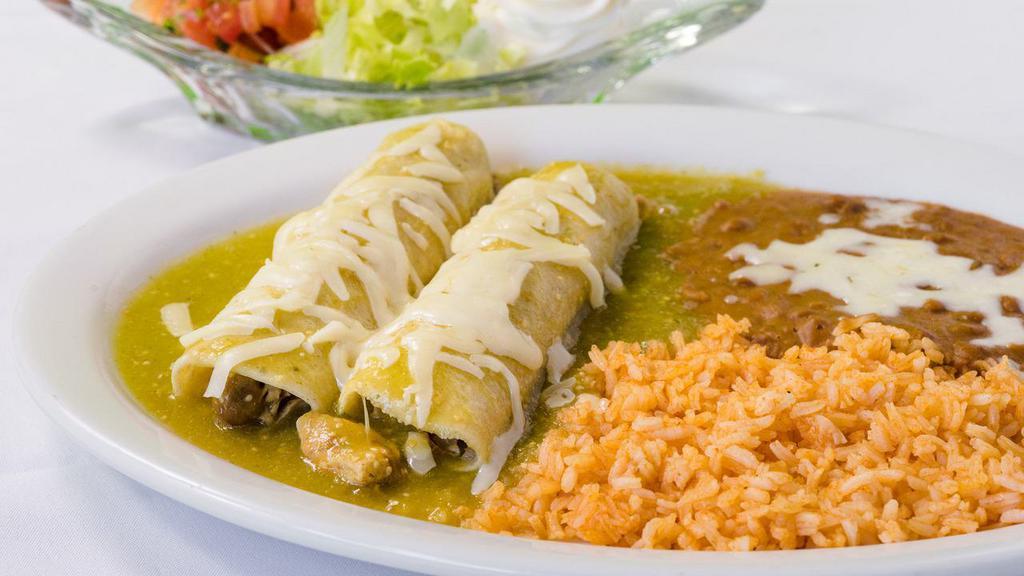 Enchilada · Red or green sauce, choice of meat, lettuce, pico de gallo, sour cream and cheese. Add shrimp or tongue for additional charge