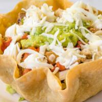 Taco Salad · A flour shell filled with lettuce, whole, pinto beans, pico de gallo, sour cream, cheese and...