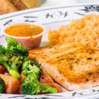 Grilled Salmon · A plate with grilled salmon fillet, served with rice, black beans, veggies and toast.