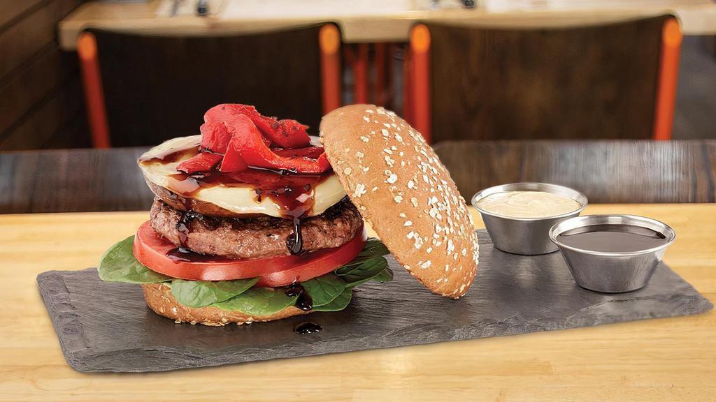 The Portobello Mushroom Burger · all-natural angus beef • baby spinach • tomatoes • marinated savory Portobello mushroom • provolone cheese • roasted red peppers • drizzled with a tangy balsamic fig glaze • served on a multigrain bun with a side of garlic aioli and balsamic fig glaze