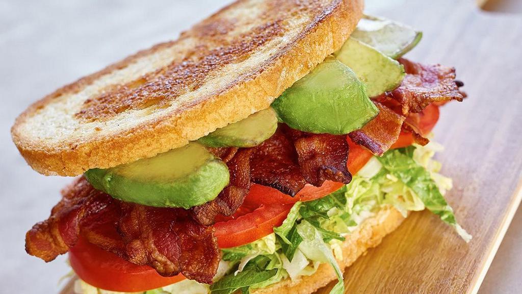 L.T. & A. · applewood smoked bacon • lettuce blend • tomatoes • avocado • garlic aioli • griddled sourdough