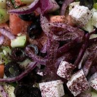 Greek Salad · Romaine hearts, tomatoes, cucumbers, onions, olives, topped with feta cheese and dressing.