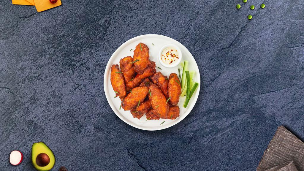 Chicken Wings · Fresh chicken wings breaded, fried until golden brown, and tossed in hot sauce. Served with a side of ranch or bleu cheese.