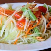 Papaya Salad · Shredded green papaya, tomatoes, chili, green beans and roasted peanuts in a Thai chili lime...