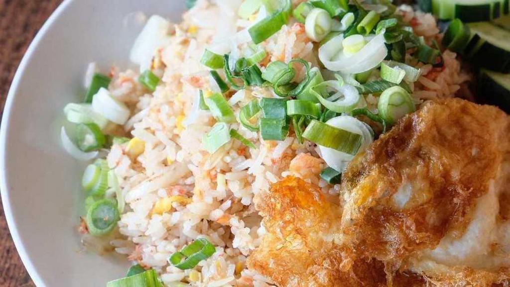Crab Fried Rice · Crab meat, eggs and onions stir-fried with jasmine rice and topped with fried egg.