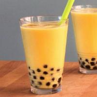 Mango tea · Mango milk tea with boba and non-dairy cream.