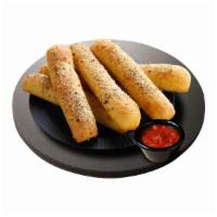 Bread Sticks · Soft & chewy breadsticks topped with garlic butter, mozzarella & Romano cheese.