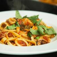 Fettuccine Alla Puttanesca · Fettuccine pasta with salmon, calamari, prawns, olives, garlic, capers and anchovy in a mild...