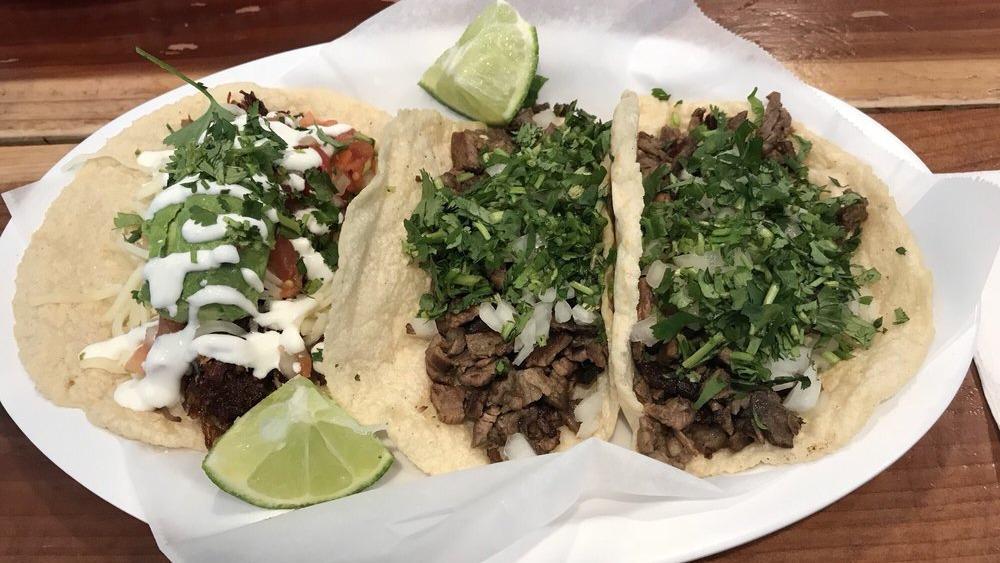 Taco Plate · Two tacos with a side of rice and beans.