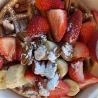 Waffle with Fruit · A Belgian waffle topped with fresh strawberries, bananas, pecans whipped cream and warm mapl...