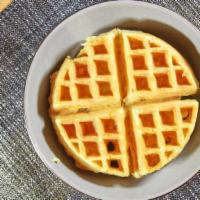 Plain Waffle · A Belgian waffle topped with butter and warm maple syrup on the side.