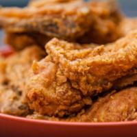 Cajun Fried Chicken Legs · Fresh-golden crispy fried chicken leg dipped in classic cajun sauce.