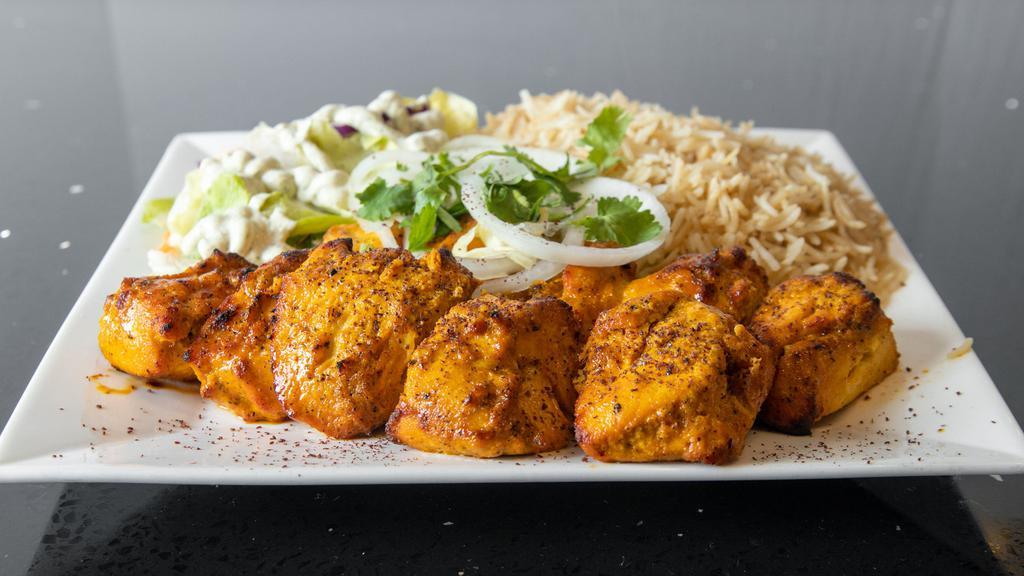 Chicken Kabob · Marinated chicken breast grilled, served with rice, salad and bread.