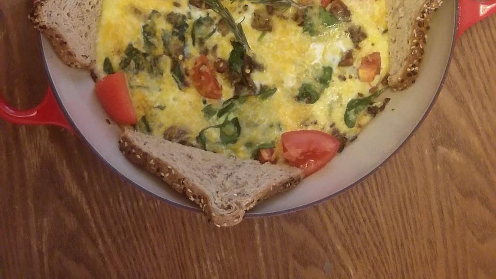 Ultimate French Omelet · Breakfast: This is a customer favorite!!! Three eggs with Roma tomatoes, fresh spinach, onions, garlic, red and green bell pepper, diced Yukon potatoes, and Applewood smoked thick-cut bacon to make this omelet a French Treat!! Served with seven-grain whole wheat bread.