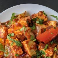 Paneer Tikka · Cottage cheese cubes (paneer) with onions and peppers in a spiced tomato glaze.