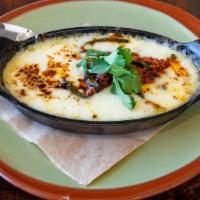 Queso Fundido · Oaxaca cheese | housemade red chorizo | rajas poblano | roasted pineapple