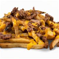 Brisket Cheese Fries · Hand cut fries smothered with jalapeño cheese sauce, topped with smoked chopped brisket