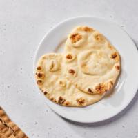 Naan · Indian flatbread, cooked tandoori style...the perfect companion to every curry, salad, and c...