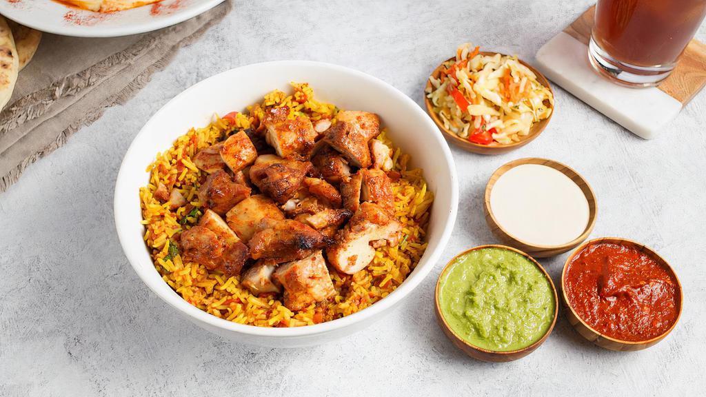 Rice Bowl with Chicken by Oren's Hummus · By Oren's Hummus. Turmeric spiced Basmati rice simmered with tomatoes, garlic, onions, mint, and parsley. Topped with a chicken skewer. Served with a side of tahini. Gluten-Free. Contains soy and nightshades. We cannot make substitutions.