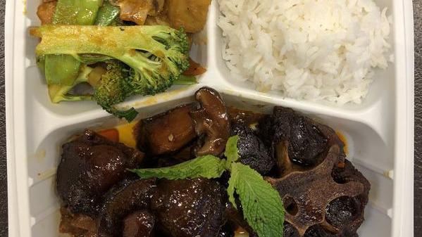 Oxtail Stew · Juicy and tender oxtail marinated with a unique 5 spice blend to create a stew rich with flavor. Served with rice and stir fried vegetables.