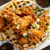 The Fried Chicken & Waffle · Large crisp belgian waffle with chef's classic fried chicken topped with syrup and butter!