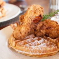 The Fried Chicken & Banana Waffles · Large crisp banana flavored belgian waffle with chef's classic fried chicken topped with syr...