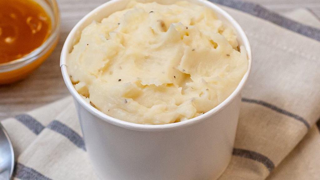 Mashed Potatoes & Gravy · Only the good stuff goes in here: real potatoes, milk, butter, and cracked black pepper. It’s whipped until soft, creamy, and silky smooth.