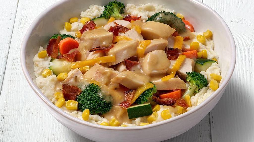 Chicken, Bacon & Cheddar Bowl · Choice of Mashed Potatoes or Cilantro Lime Rice topped with all-white rotisserie chicken, cheddar cheese, corn, steamed vegetables, roasted garlic & herb sauce, and fresh bacon crumbles.