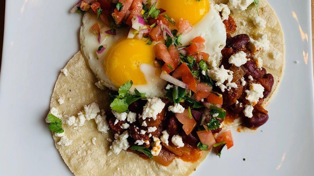 Huevos Rancheros · 2 eggs your way on 2 corn tortillas, with black beans , pico de gallo, feta cheese, and home fries.