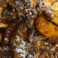 Louise · Caramelized foster bananas,  Nutella, spiced walnuts and bacon. Served with syrup.