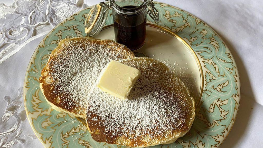 Plain Buttermilk Pancakes · 2 Large buttermilk pancakes served with butter and syrup.