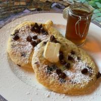 Chocolate Chip Buttermilk Pancakes · 2 large buttermilk pear pancakes with syrup and butter.