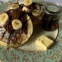 Nutella Banana Buttermilk Pancakes · 2 large buttermilk Nutella- banana pancakes with syrup and butter.