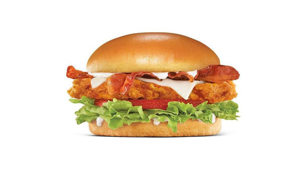 Hand-Breaded Bacon Swiss Chicken Sandwich · Premium, all-white chicken fillet, hand dipped in buttermilk, lightly breaded and fried to a golden brown, topped with bacon, Swiss cheese, lettuce, tomato, and mayonnaise on a potato bun..