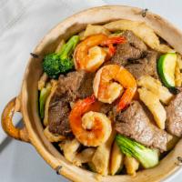 Claypot Rice · Combination of prawns, beef, chicken, zucchini, mushrooms, broccoli, and soy sauce rice.  Pa...
