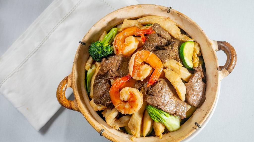 Claypot Rice · Combination of prawns, beef, chicken, zucchini, mushrooms, broccoli, and soy sauce rice.  Pan Fried then baked to a crisp in a claypot.