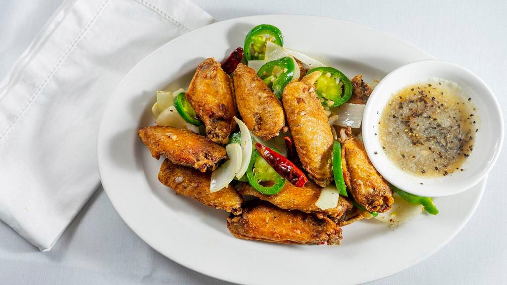 Spicy Chicken Wings · Chicken wings pan fried w/ onions, jalepeno and red peppers.