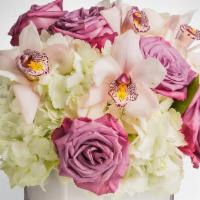Pop of Lavender · Elegant design in a square container includes Hydrangeas, pink roses,  and Orchids.
