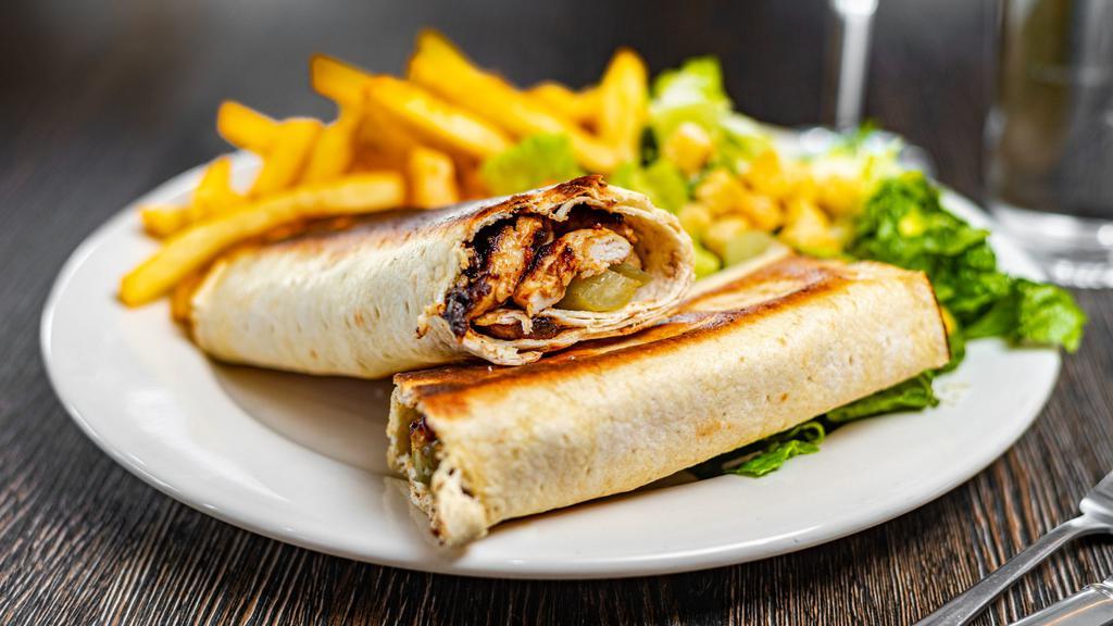 Chicken Shawarma · Served in lavash bread with creamy garlic sauce and pickles, served with Caesar salad.