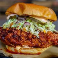 Nashville Hot Chicken Sandwich · Hand breaded chicken breast tossed in hot oil with Nashville spice mix, topped with slaw, pi...
