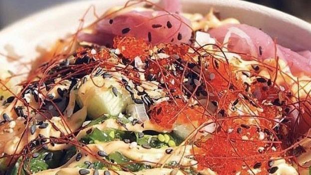 Rainbow Salmon · Gluten-free. Salmon, cucumber, carrots, pineapple, seaweed salad, green onion, edamame, roasted seaweed, tempura flakes with house aioli.