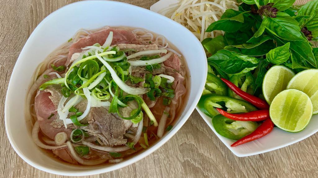 Well-Done Flank Steak Pho · Well done Flank Steak and Rice Noodles in a Fragrant Beef Both served with Bean Sprouts, Basil 🌿 , Limes , Hoisin and Chili 🌶  Sauce & Peppers ..