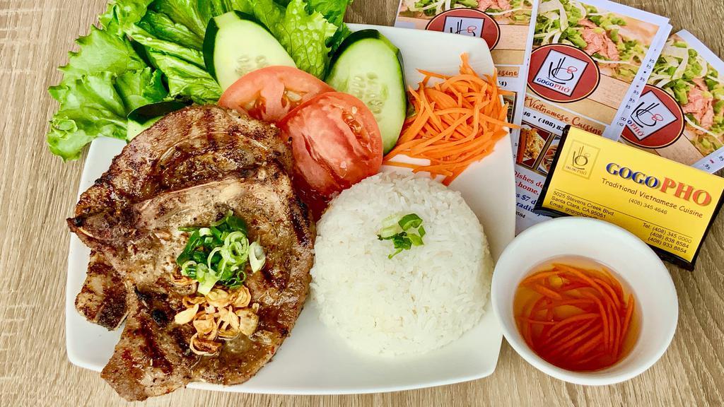 Grilled Pork Rice Platter · With: 
 Grilled Pork Chop and Steamed Rice , Lecture 🌿 , Tomato 🍅  , Cucumber  🥒  , Carot , Great Onions  & Fried Onions , Sweet & Sour Sauce