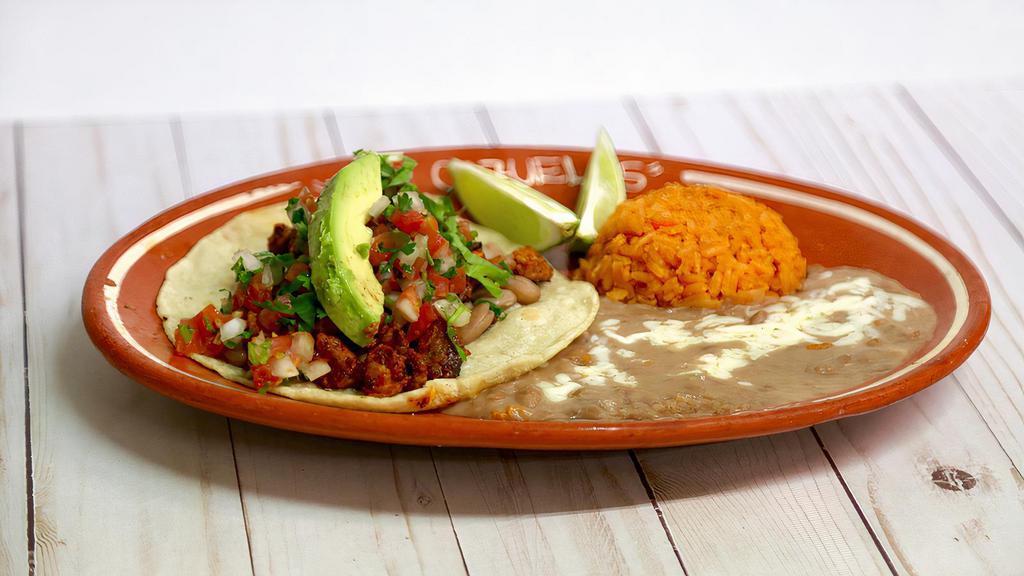3. One Soft Taco Platter · Corn tortilla,  choice of meat (chicken, steak or carnitas) topped with avocado and pico de gallo served  with a side of rice and beans.