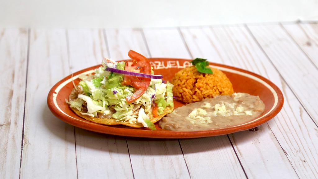 5. One Tostada De Queso Platter · One Cheese tostada. lettuce, tomatoes,  cotija cheese, onions, guacamole with rice and beans.