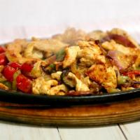 31. Fajitas Plate · Chicken or steak. Served with rice, beans, guacamole, sour cream and tortillas.