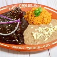 20. Chicken Mole Plate · Autentic Cazuelas Platter  with our specialty mole souce home made,  rice, beans and tortill...